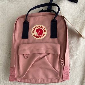 Mini Fjallraven Kanken Backpack in pink and navy.